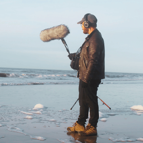 Picture of Mikkel looking at the waves with a microphone