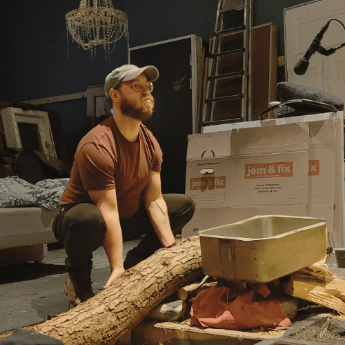 Picture of Mikkel recording Foley sounds with a huge log
