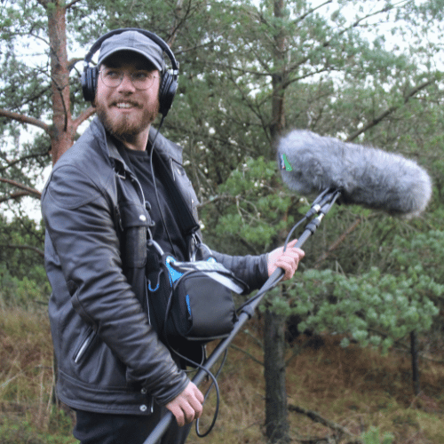 Picture of Mikkel smiling with sound equipment